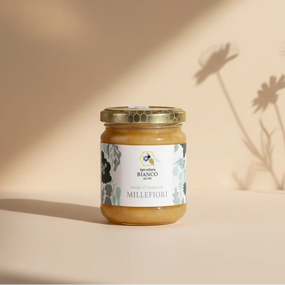 Jar of wildflower honey from Abruzzo with a decorative label on a artistic background